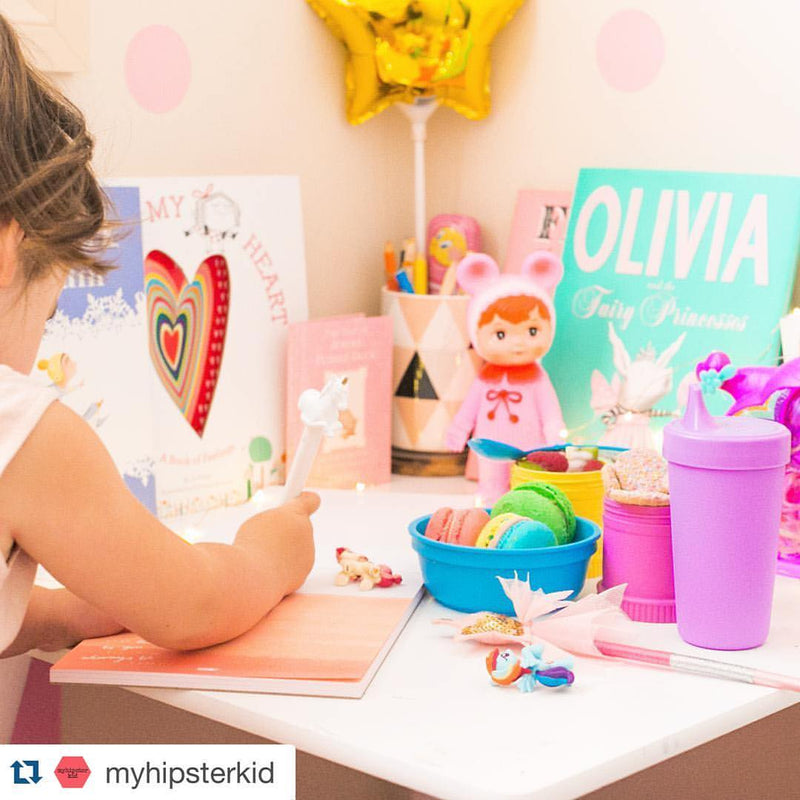 Soft toys and books styled on a shelf